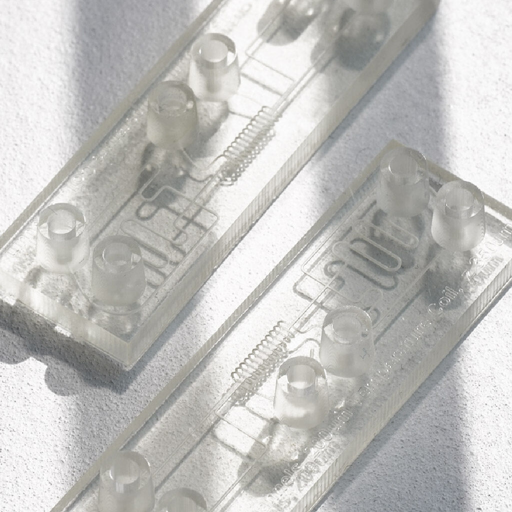 A clear encapsulated device in microfluidics is transparent, offering both protection and visibility of fluidic processes.
